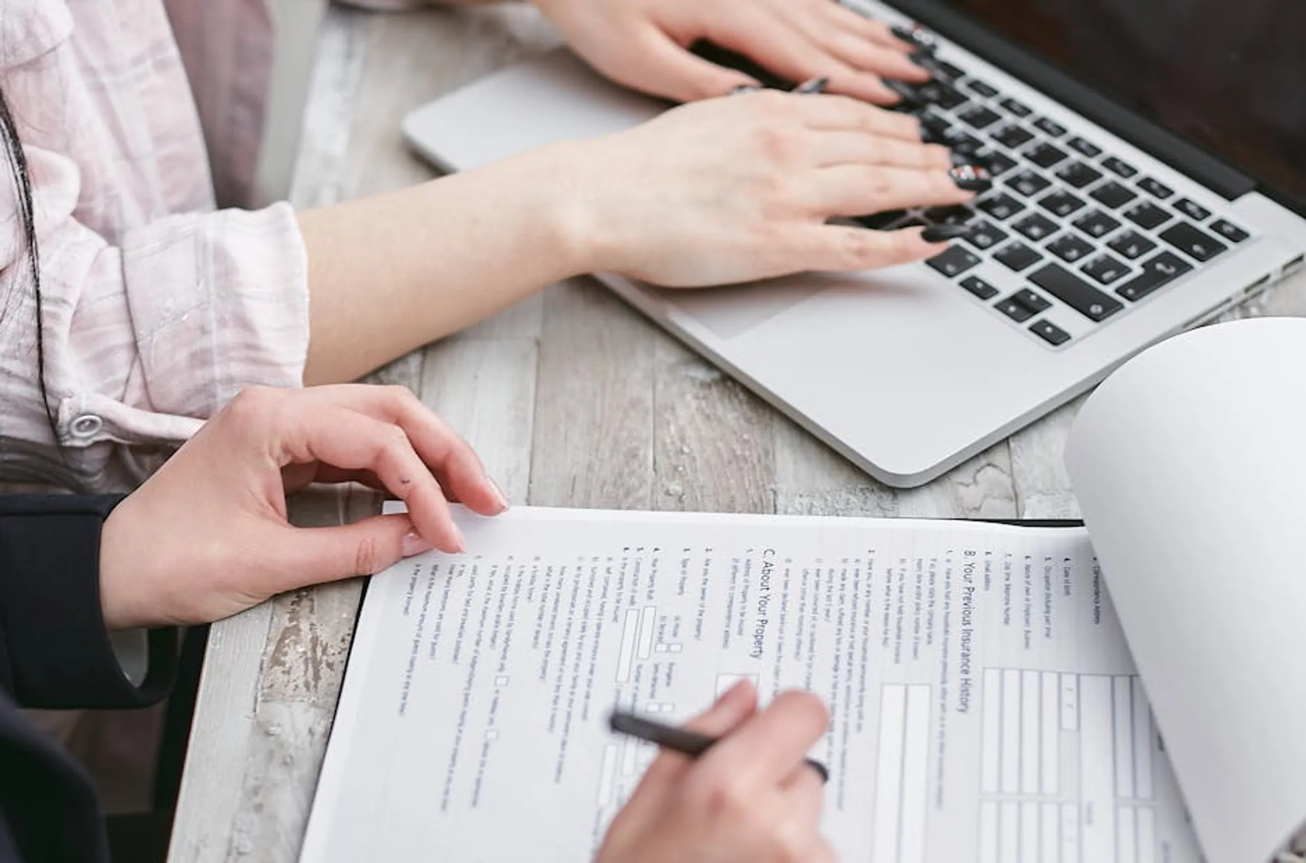 Close-up of hands typing on a laptop and reviewing business documents, focused on finance and legal tasks. Illustration showing different types of personal loans like traditional bank, online, and peer-to-peer